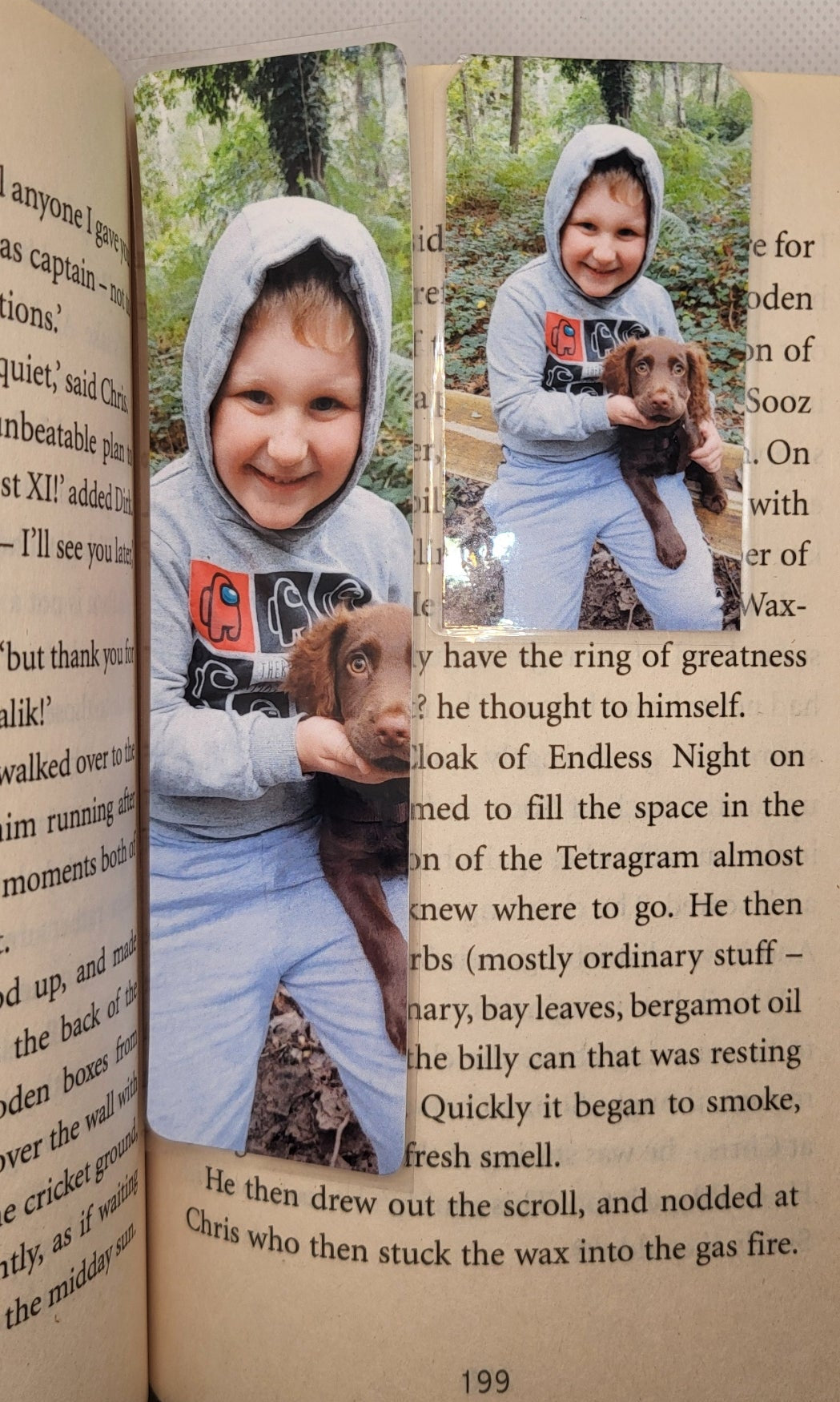 Large and magnetic bookmarks featuring a boy and a dog on a book with a white background