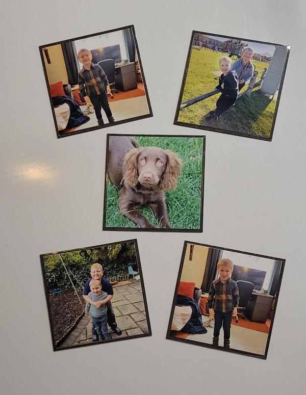 Five framed photographs on a wall next to a textured wall.