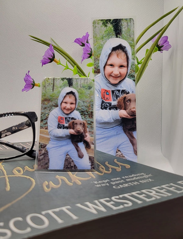small and large bookmarks with a book, reading glasses and flowers on a white background