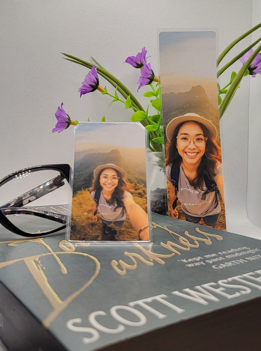 large and small bookmarks featuring a woman hiking, with reading glasses, flowers and a book on a white background