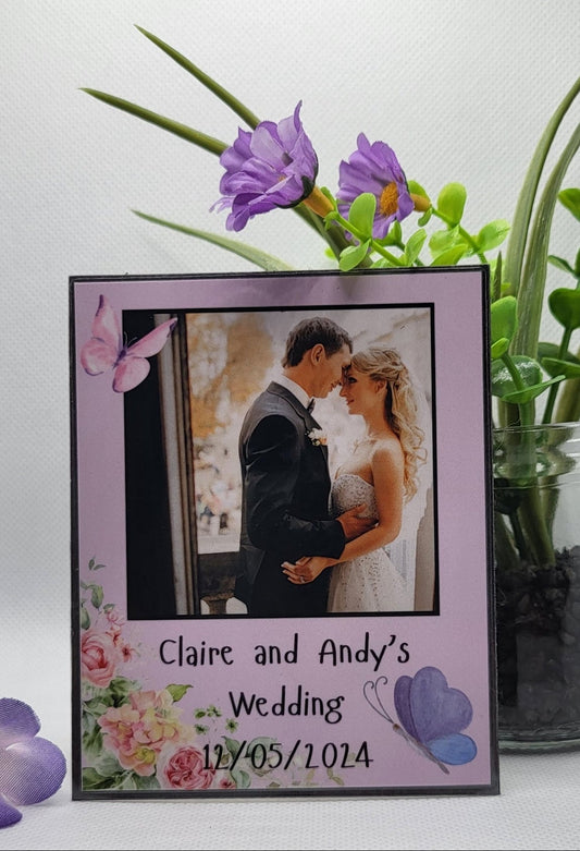 Personalized photo frame with a couple's wedding picture and date, surrounded by flowers on a white background.